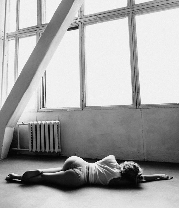 Woman in a graceful yoga pose in a bright, peaceful studio.
